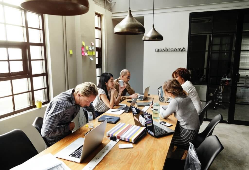 People around table not paying attention to meeting